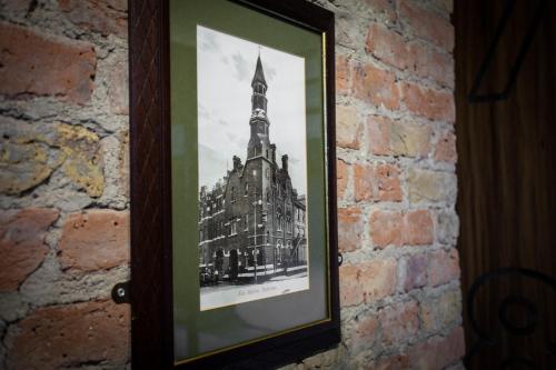 a picture of a building on a brick wall at PubLove @ The Crown, Battersea in London