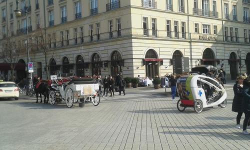 a group of horse drawn carriages in front of a building at Berlin - Schönefeld grüne Wohnung in Schönefeld
