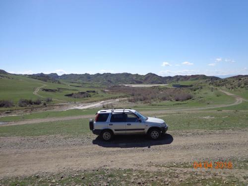 a white suv parked in the middle of a field at My home udabno in Udabno