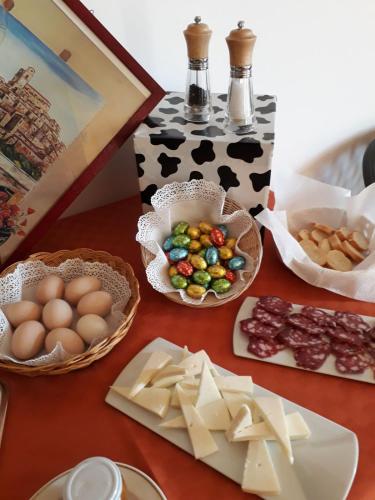 a table with cheese and other foods on it at Bed & Breakfast Valeri in Artena