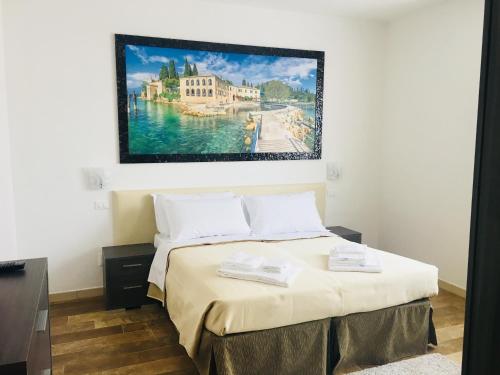 Ce lit se trouve dans un dortoir orné d'une peinture murale. dans l'établissement Cabà Holiday Bardolino D'Annunzio, à Bardolino