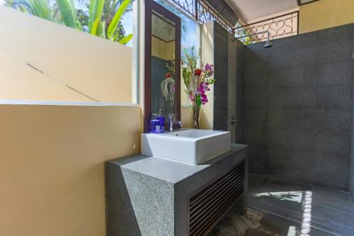 a bathroom with a white sink on a wall at 5 Islands Beach Villa @ Lipa Noi in Lipa Noi