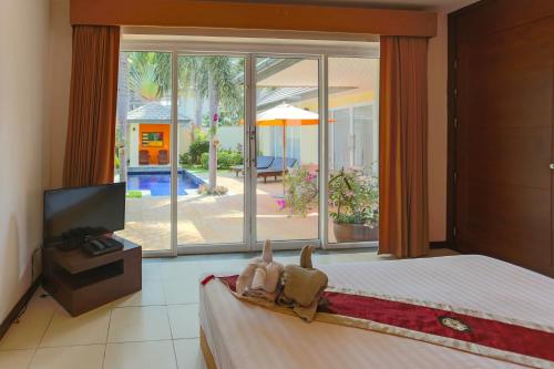 a bedroom with a bed and a large window at 5 Islands Beach Villa @ Lipa Noi in Lipa Noi