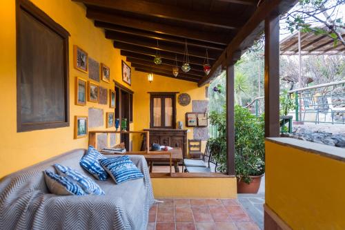 a bedroom with a bed in a yellow wall at Bohemian Hideaway Finca - 2 unique houses with shared pool in Santa Lucía