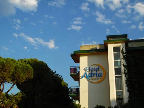 a hotel alpha sign on the side of a building at Hotel Adria in Lignano Sabbiadoro