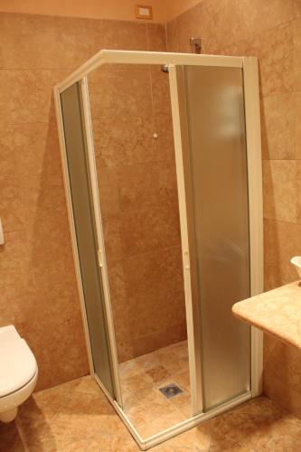 a shower stall in a bathroom with a toilet at Hotel La Dolce Vita in Cavaion Veronese