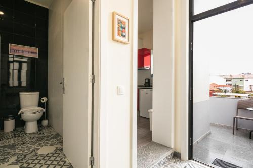a bathroom with a toilet and a sink at À Francos Artist Painting in Porto