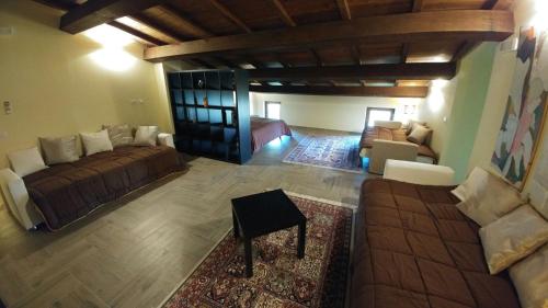 a large living room with a couch and a table at Casa Francesconi in Pietra Rossa