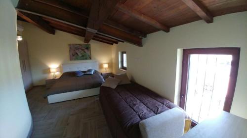 a bedroom with two beds and a sliding glass door at Casa Francesconi in Pietra Rossa