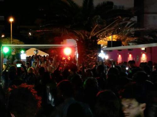 a crowd of people standing in front of a building at night at B&B Da Peo in Porto San Giorgio