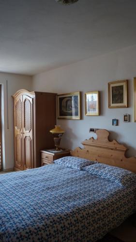 a bedroom with a large bed with a blue bedspread at B&B L'Arca di Noè in Laion