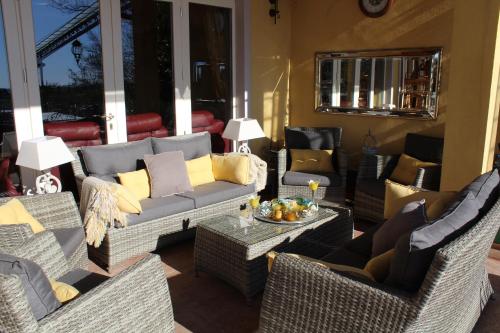 a living room with wicker chairs and a couch at Hotel La Dolce Vita in Cavaion Veronese
