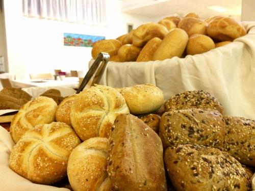 a bunch of different types of bread on a table at Hotel Adria in Lignano Sabbiadoro