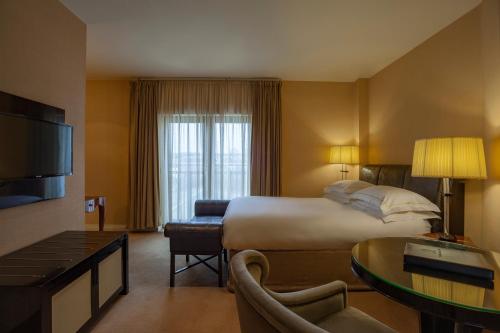 a hotel room with a bed and a living room at Lord Bagenal Inn in Leighlinbridge