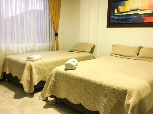 Postel nebo postele na pokoji v ubytování HYG Hotel