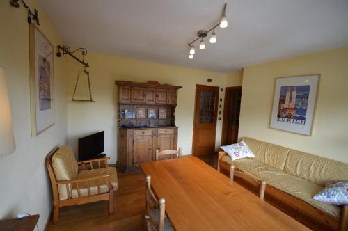 a living room with a couch and a table at Anna House in Celerina