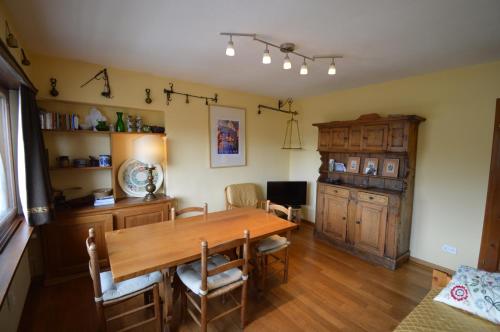 a dining room with a wooden table and chairs at Anna House in Celerina