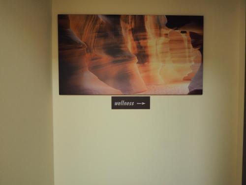 a picture hanging on a wall with a poster on it at Pension Inspirace a Wellness self check-in in Kolín
