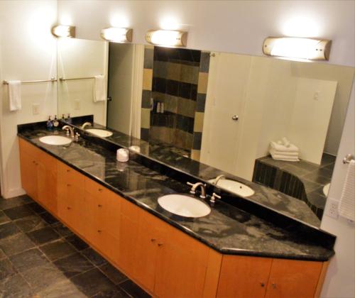 a bathroom with two sinks and a large mirror at Modern B & B in Houston