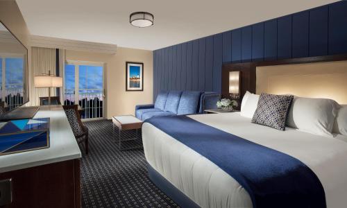 a hotel room with a large bed and a desk at Hyannis Harbor Hotel in Hyannis