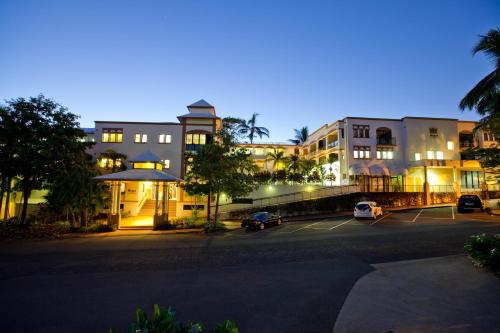 a parking lot in front of a building at night at Regal Port Douglas in Port Douglas