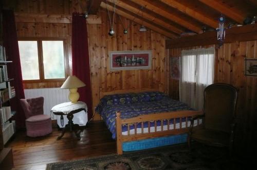a bedroom with a bed in a wooden cabin at Chalet Vaclav in Sixt