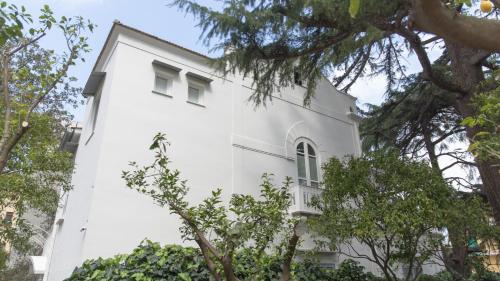 a white building with trees in front of it at Villa Manning Relais in Sorrento