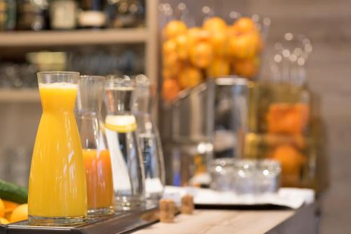 two glasses of orange juice sitting on a counter at Hotel Schwarzer Bär in Linz