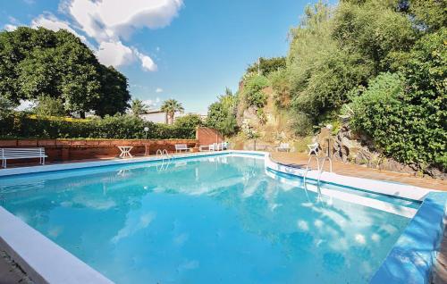 a large swimming pool with blue water at Villa Rama in Aci Castello