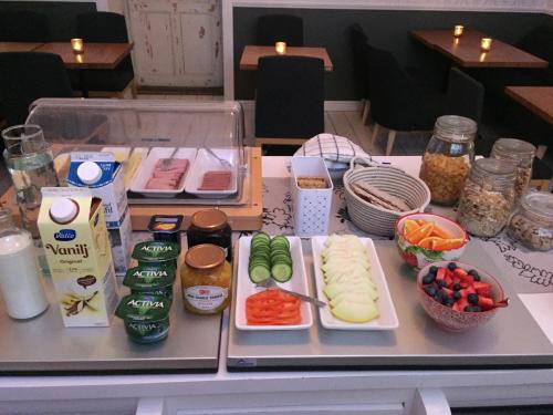 a table with vegetables and other food items on it at Norrfly Herrgård in Kilafors