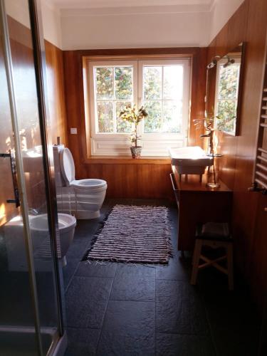 a bathroom with a toilet and a sink and a window at Casa da Lapa in Aspra