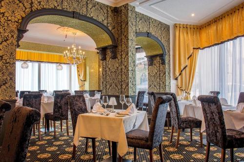 a restaurant with tables and chairs in a room at Revelstoke Hotel in Bridlington