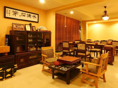 a dining room with chairs and a table and a dining room at At Chiang Mai Hotel in Chiang Mai
