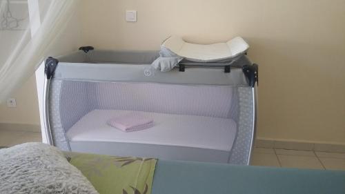 a hospital bed with a white crib in a room at villa bananas in Saint-François
