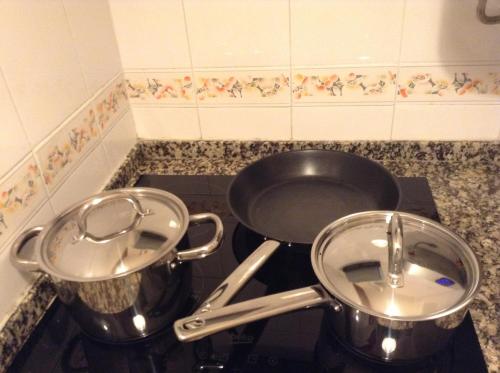 two pots and pans sitting on top of a stove at Apartment Estrela Heart in Lisbon