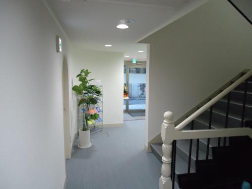 a hallway with a staircase and a stair case at Shin-Okubo City Hotel in Tokyo