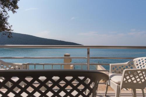 a balcony with chairs and a view of the water at Seaside Apartment Kruče in Kruče