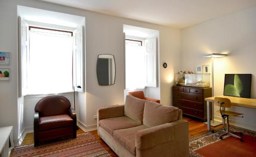a living room with a couch and a chair at Saldanha Apartment in Lisbon