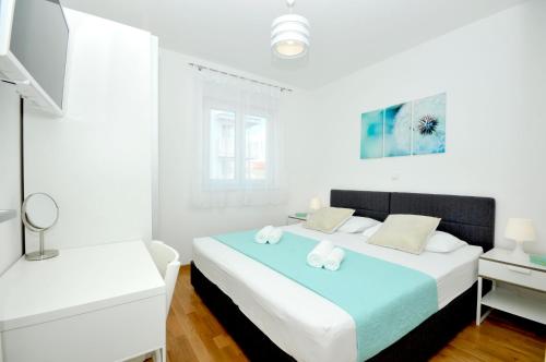 Posteľ alebo postele v izbe v ubytovaní Apartments Town