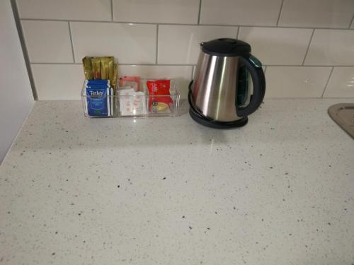 a coffee pot sitting on top of a kitchen counter at Addison Motor Inn in Shepparton