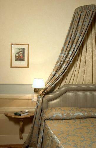 a bedroom with a bed with a canopy at Palazzo Niccolini al Duomo Residenza D'Epoca in Florence