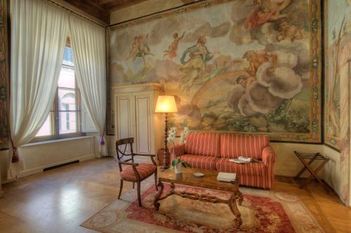 a living room with a couch and a painting on the wall at Palazzo Niccolini al Duomo Residenza D'Epoca in Florence