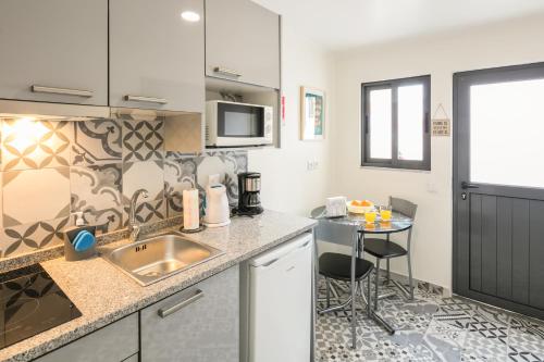 a kitchen with a sink and a counter top at À Francos Love Lair 2 in Porto