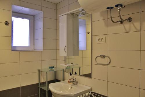 a bathroom with a sink and a mirror at Istrian Sunrise in Koper