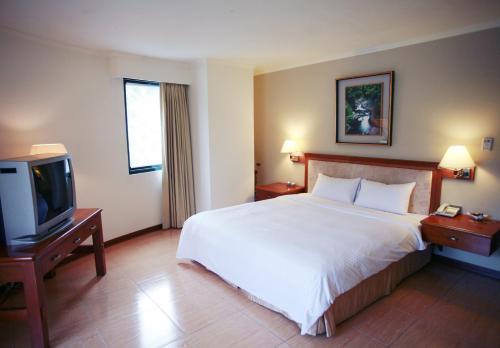 Ένα ή περισσότερα κρεβάτια σε δωμάτιο στο King's Resort & Spa