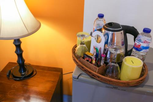 a basket on top of a refrigerator next to a lamp at Aquarius Beach Hotel in Sanur