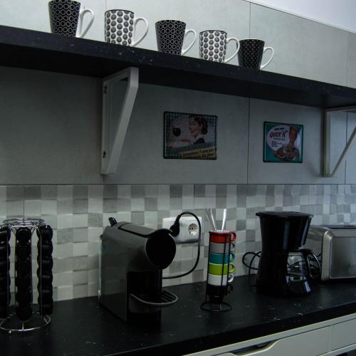 a kitchen counter with a coffee maker and a toaster at Lisbon Hostel Terminal 3 in Lisbon