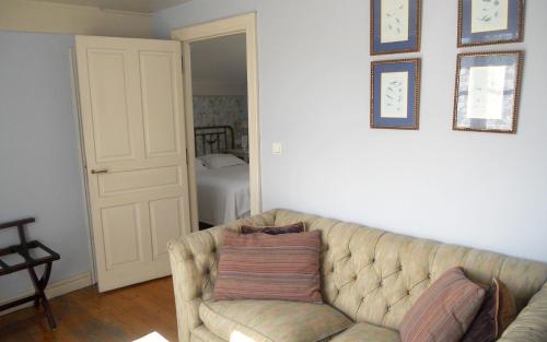 a living room with a couch with a pillow on it at Hotel Casona del Sella in Arriondas