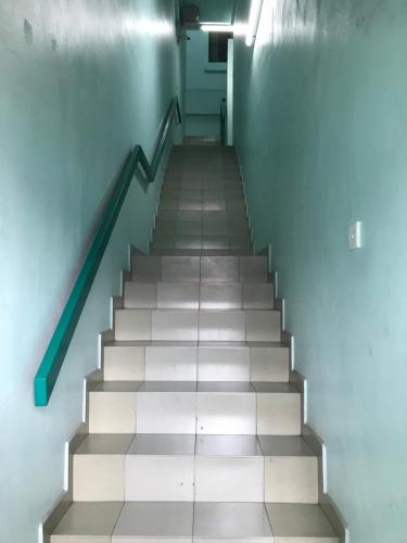 a stairway with a blue wall and a stair case at Hotel dan Restoran Seri Kangsar in Kuala Kangsar