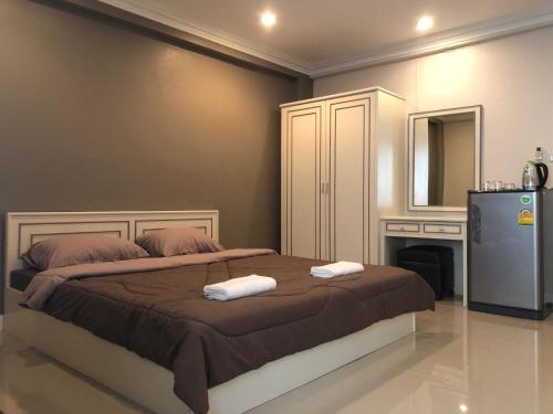 a bedroom with a bed with two towels on it at M. Swita เอ็ม.สวิต in Bangkok